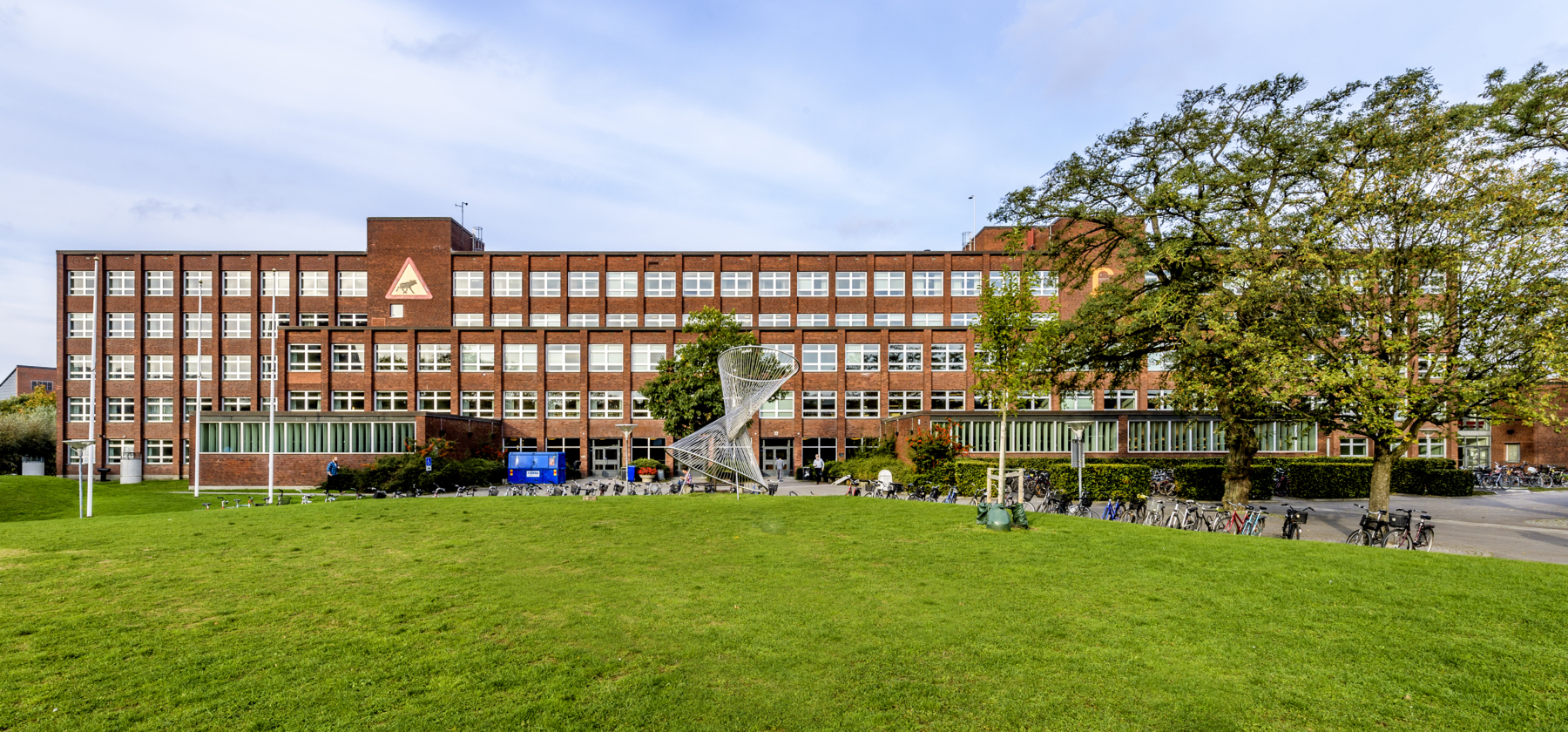 Mathematics building with grass in front of it. Photo.